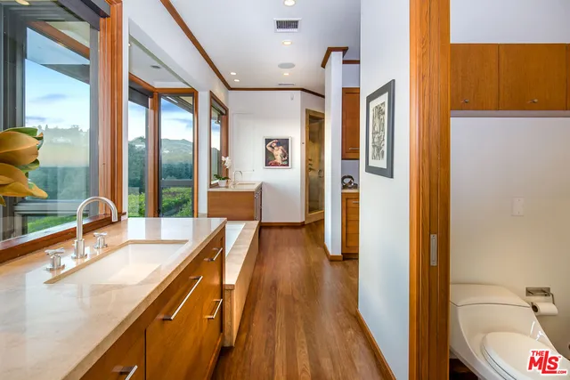 a bathroom with a sink a mirror and a shower