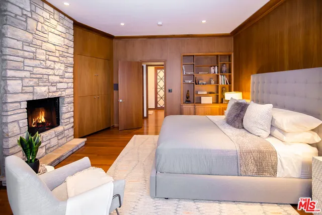 a bedroom with a bed and a fireplace