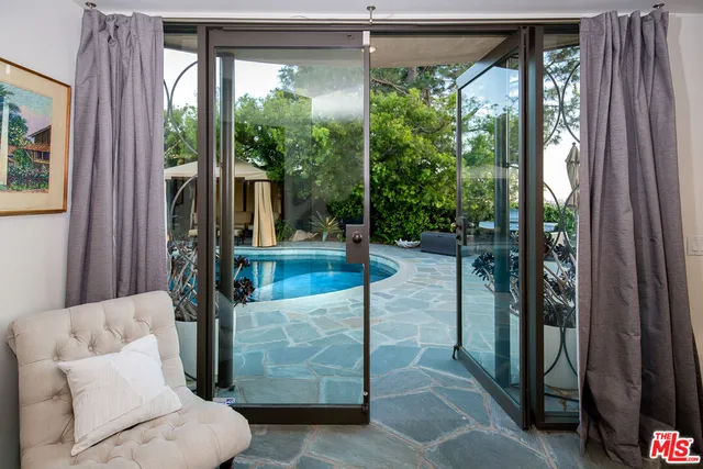 a living room with furniture and a floor to ceiling window