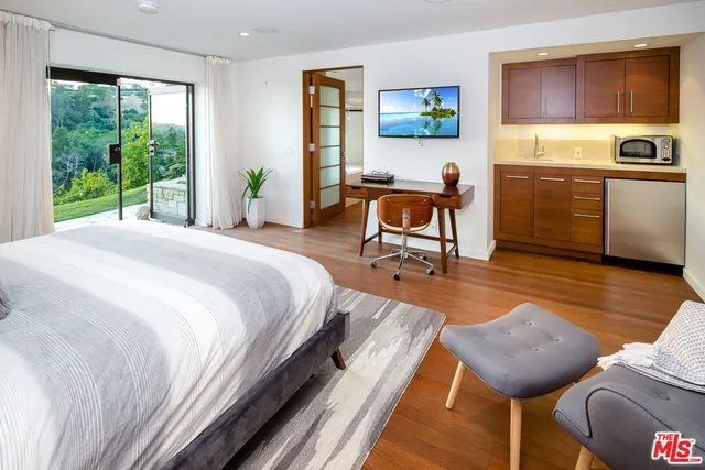 a bedroom with furniture and a window