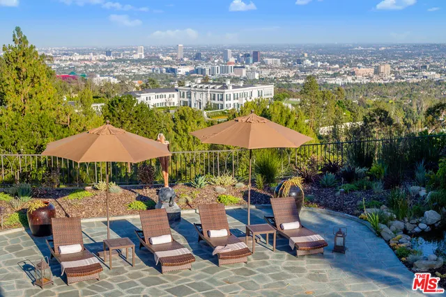a view of a patio with furniture and a yard