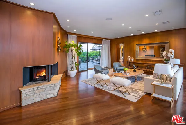 a living room with fireplace furniture and a flat screen tv