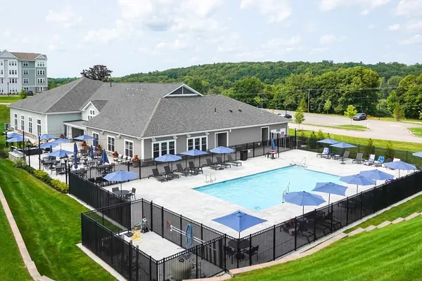 a view of a house with pool and a yard
