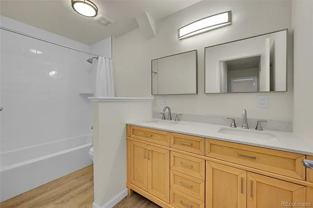 a bathroom with a granite countertop sink mirror and double