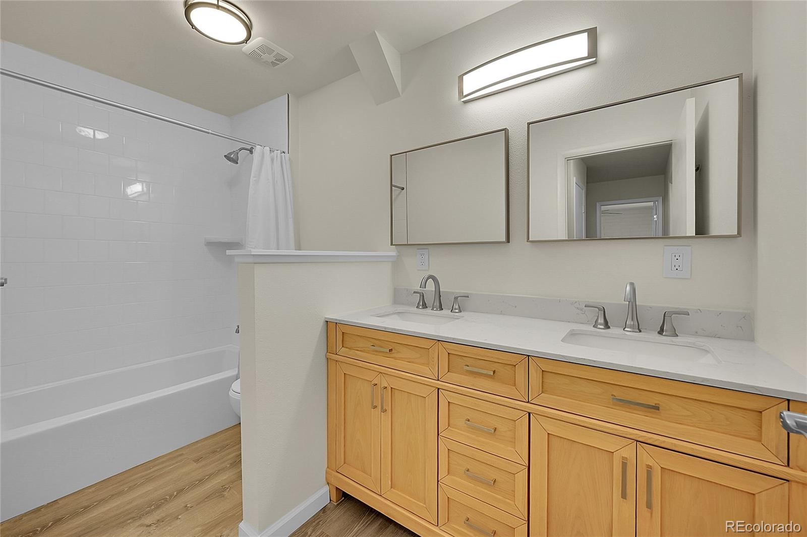 1130 South Clinton Street, Unit 68 Denver, CO 80247 - Photo 12 of 18 a bathroom with a granite countertop sink mirror and double