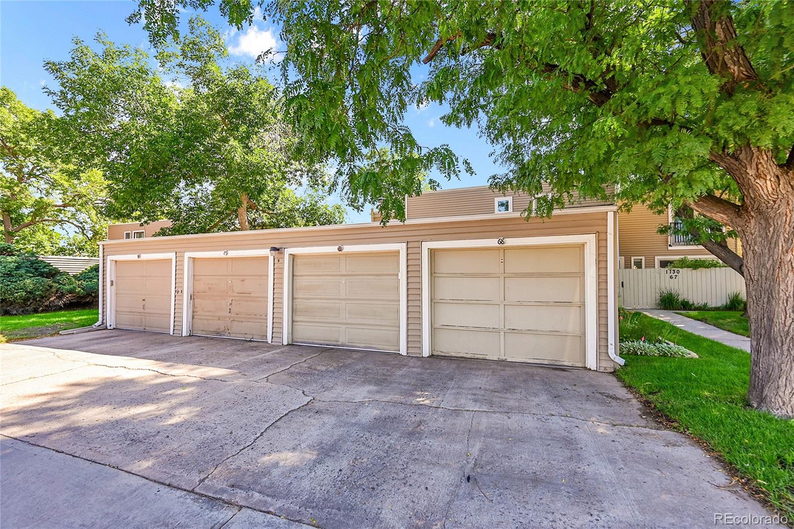 1130 South Clinton Street, Unit 68 Denver, CO 80247 - Photo 13 of 18 front view of a house with a garage