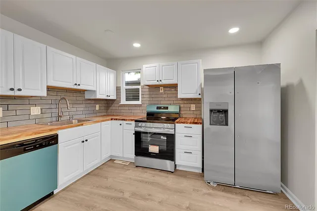 a kitchen with cabinets stainless steel appliances and a counter space