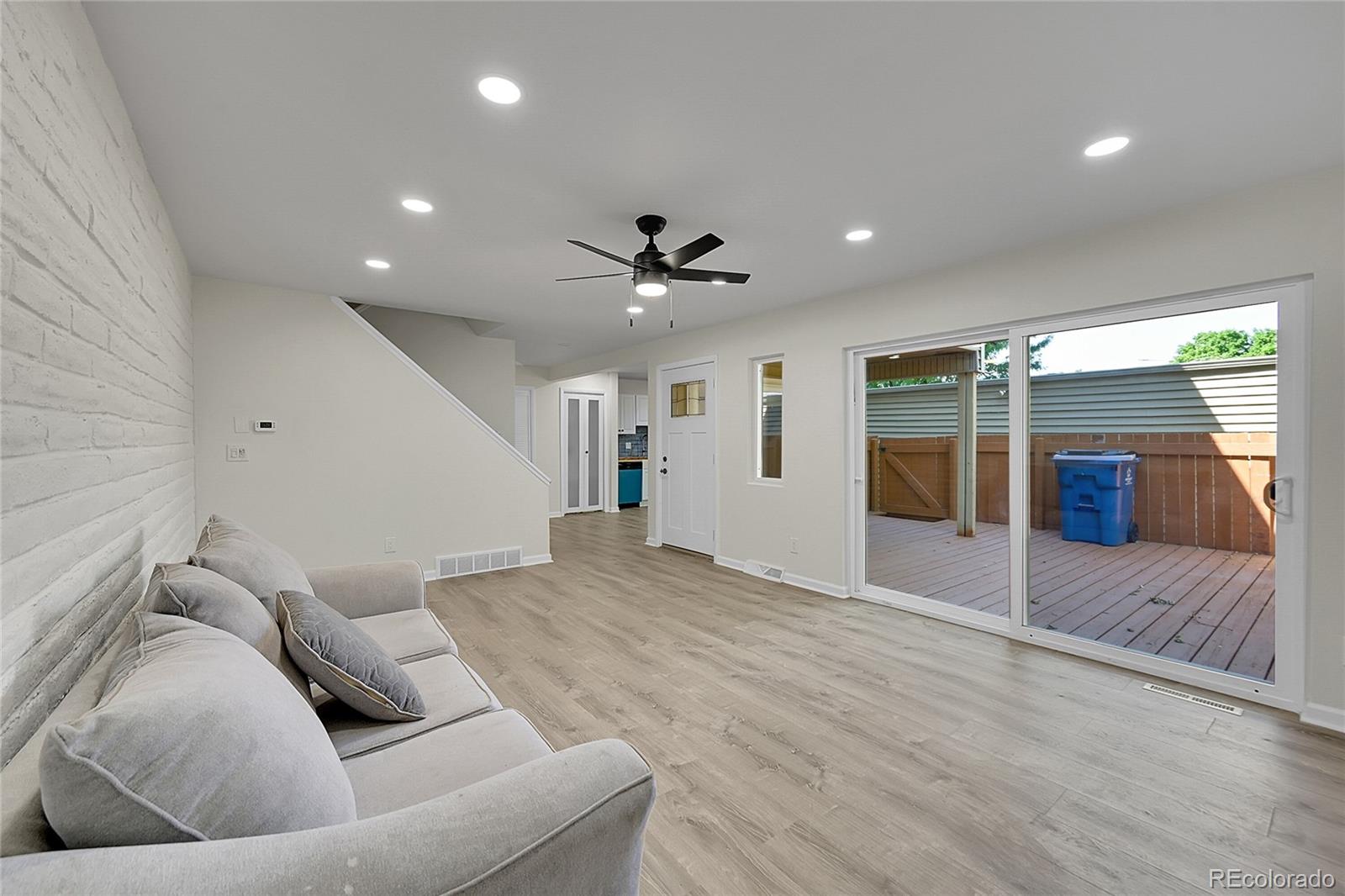 1130 South Clinton Street, Unit 68 Denver, CO 80247 - Photo 4 of 18 a living room with furniture and a large window