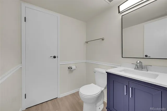a bathroom with a sink toilet and vanity