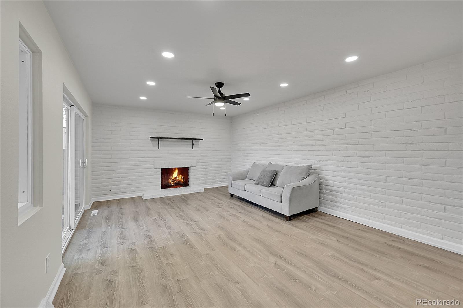 1130 South Clinton Street, Unit 68 Denver, CO 80247 - Photo 7 of 18 a living room with furniture and a fireplace