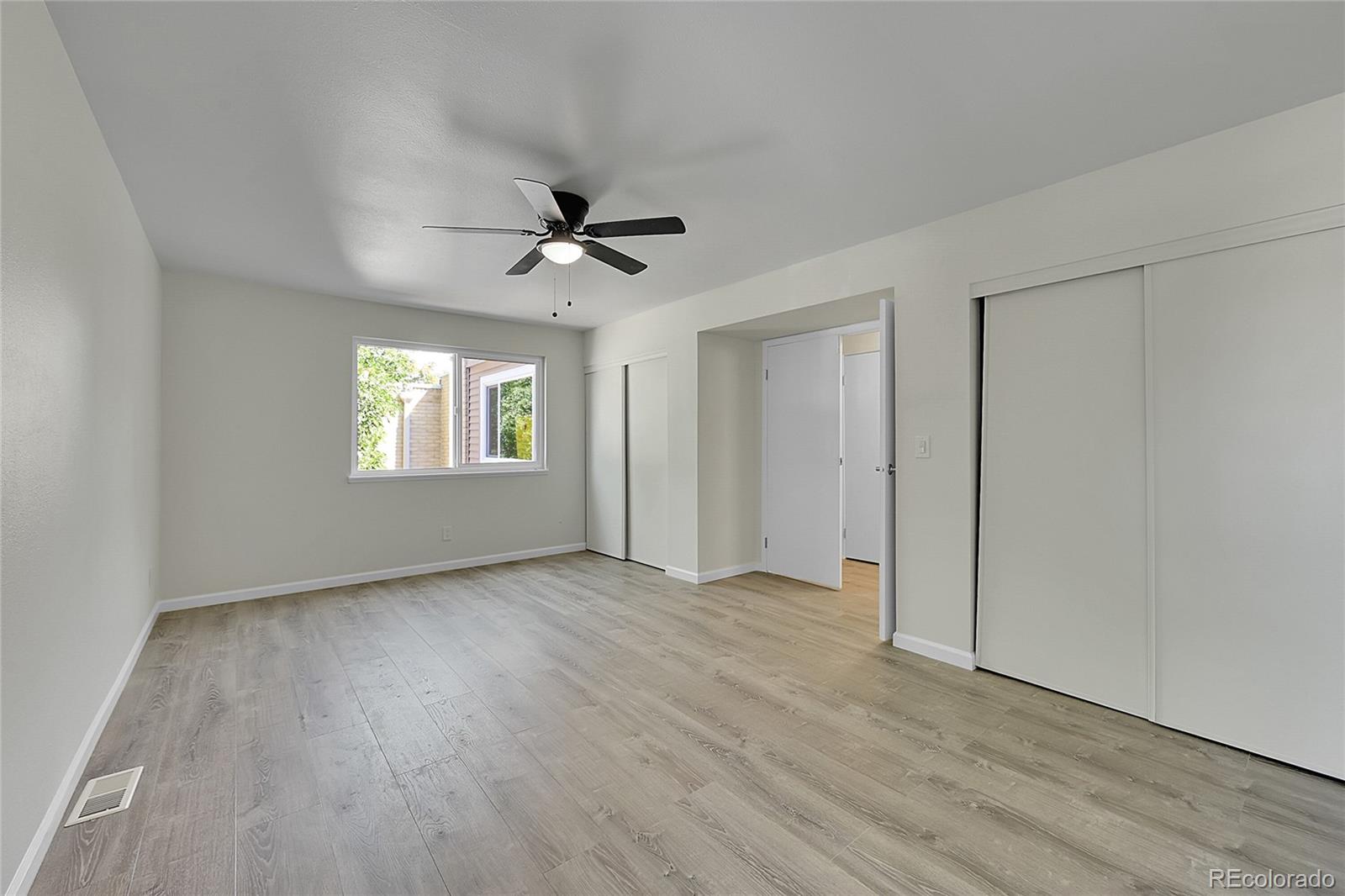 1130 South Clinton Street, Unit 68 Denver, CO 80247 - Photo 9 of 18 a view of an empty room with a window