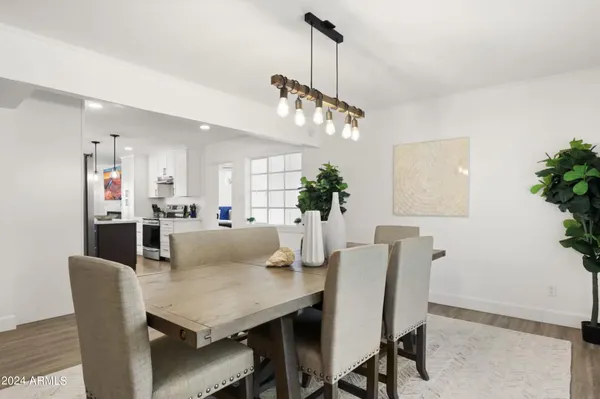 a view of a dining room with furniture and a chandelier