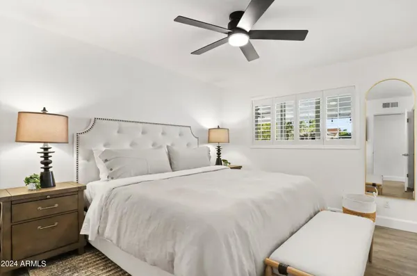 a bedroom with a large bed and a window