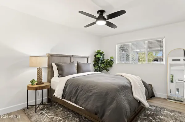 a large bed sitting in a bedroom next to a window