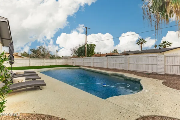 a view of a swimming pool with a yard