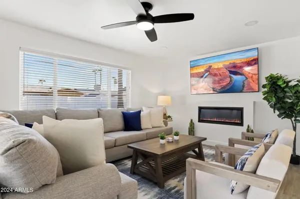 a living room with furniture a fireplace and a flat screen tv