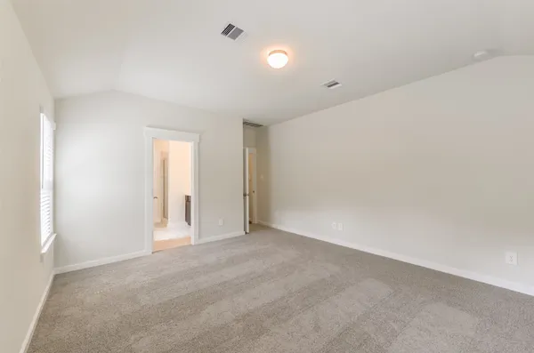 an empty room with windows and chandelier fan