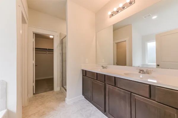 a bathroom with a double vanity sink and a mirror