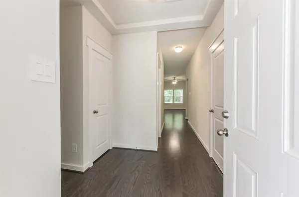 a view of a hallway with wooden floor