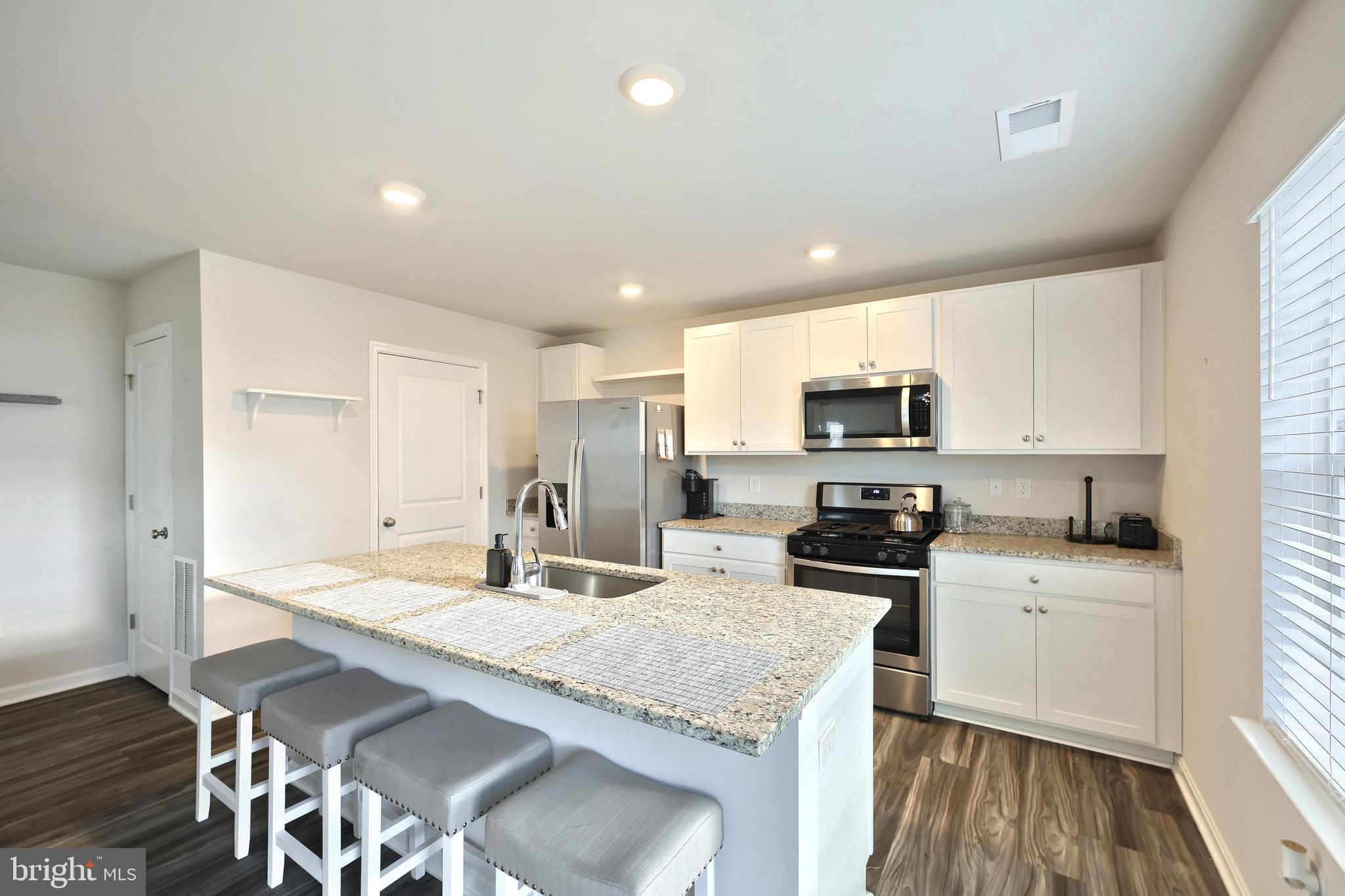 90 Knobby Hook Drive Hanover, PA 17331 - Photo 21 of 48 a kitchen with granite countertop a sink stove microwave and refrigerator