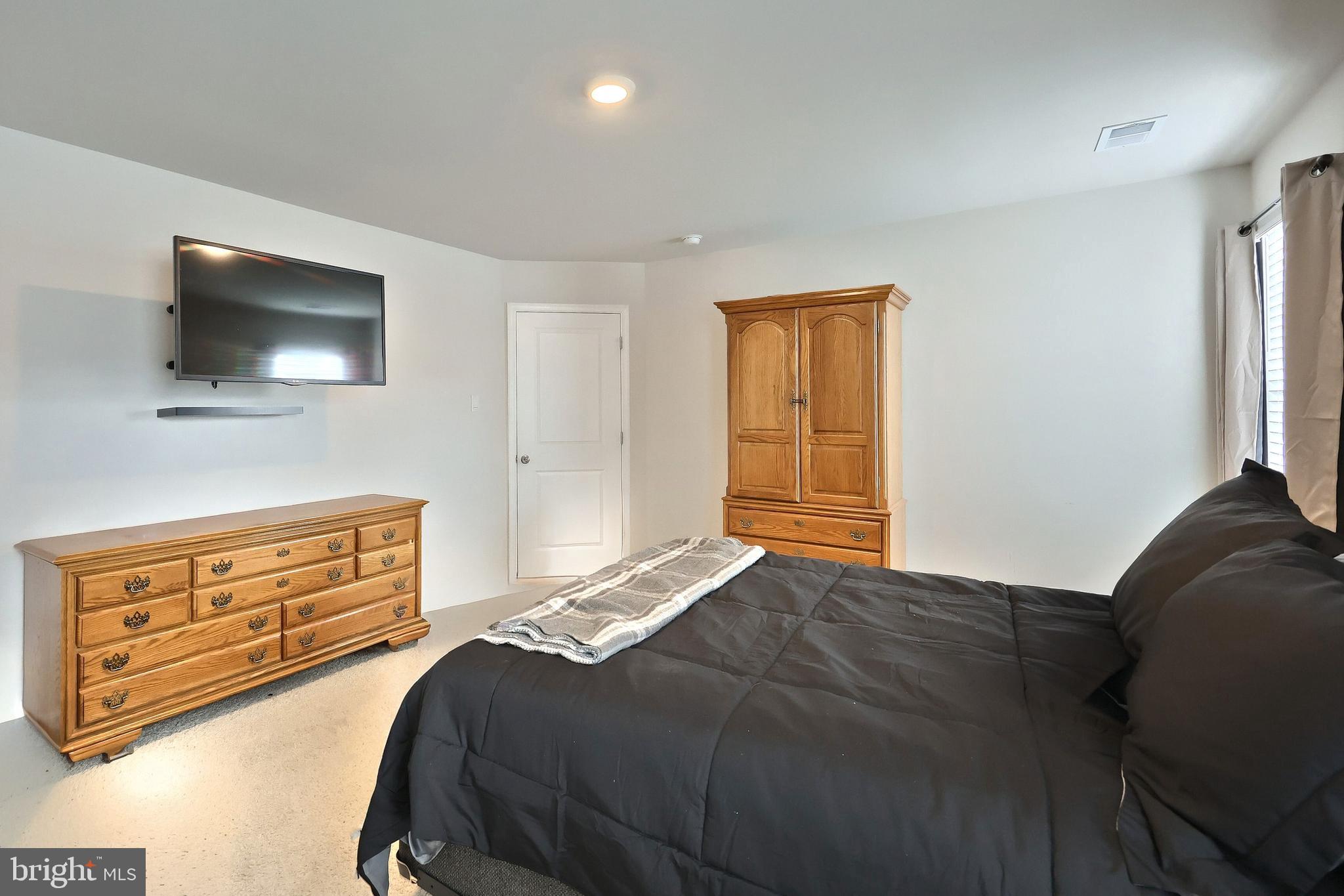 90 Knobby Hook Drive Hanover, PA 17331 - Photo 32 of 48 a bedroom with a bed and a television