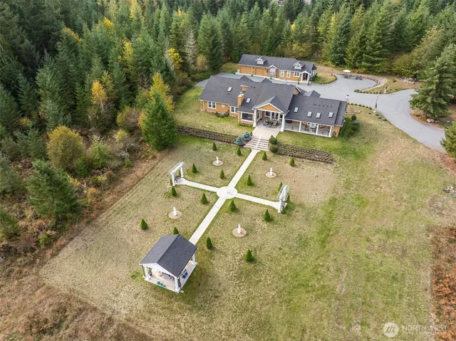 an aerial view of a house with a yard and trees