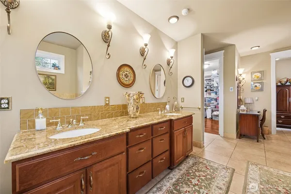 a bathroom with a tub a sink and glass door