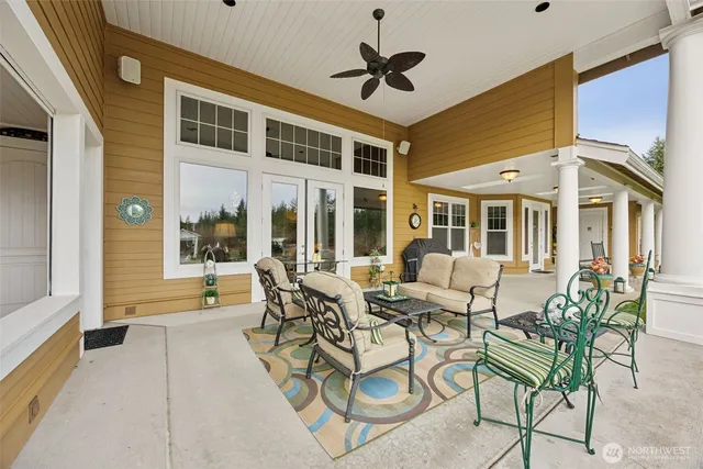 a kitchen with stainless steel appliances granite countertop a stove top oven a sink dishwasher and white cabinets with wooden floor