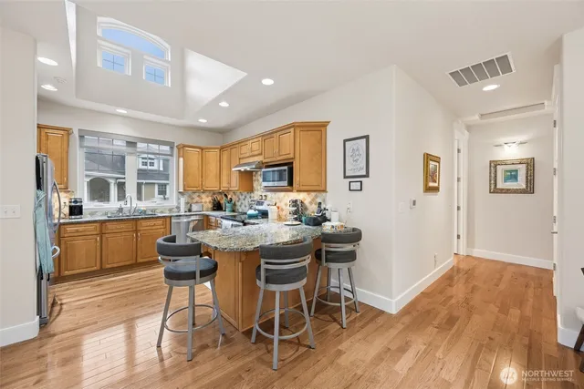 a dining room with furniture a chandelier and wooden floor