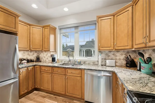a dining room with furniture a chandelier and wooden floor