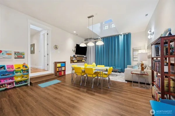 a living room with furniture a rug and a chandelier