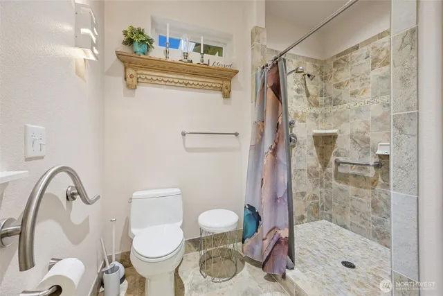 a kitchen with granite countertop white cabinets sink and window