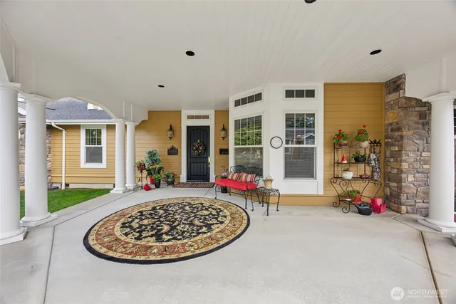 a living room with furniture a rug and a fireplace