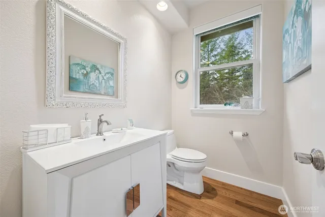 a kitchen with granite countertop white cabinets sink and window