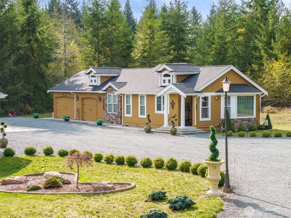 a front view of a house with a garden