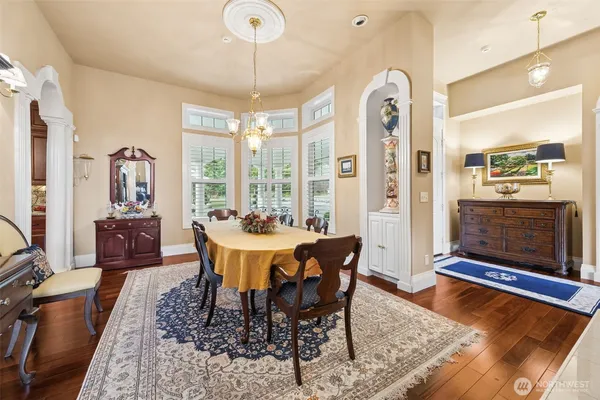 a view of a dining room with furniture window and wooden floor
