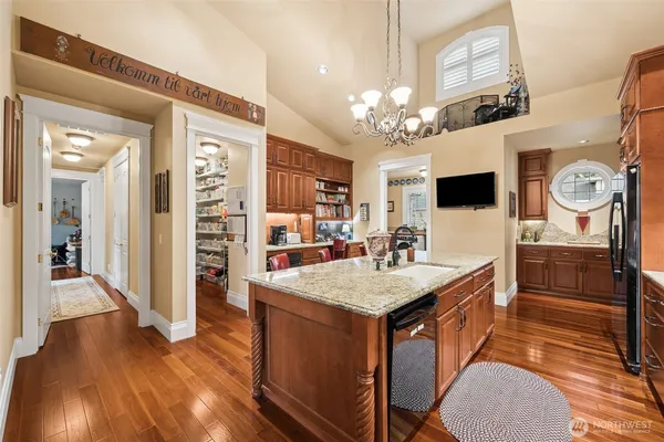a view of a dining room with furniture a chandelier and wooden floor
