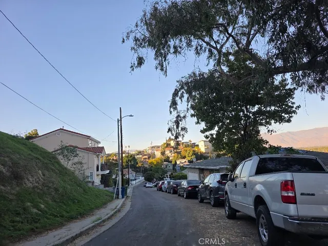 a view of a cars park on the side of a road