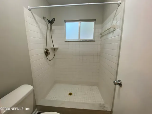 a bathroom with a shower and toilet
