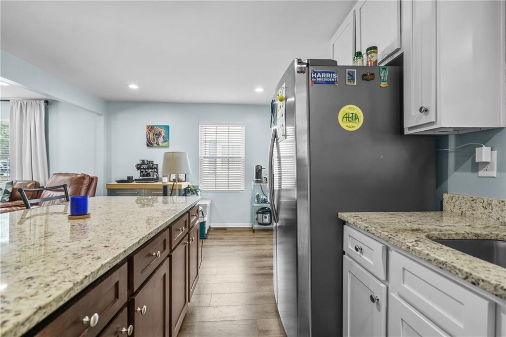 2444 Constance Street Atlanta, GA 30344 - Photo 17 of 39 a kitchen with sink granite counter tops and chairs
