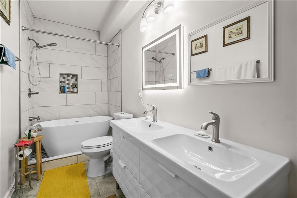 2444 Constance Street Atlanta, GA 30344 - Photo 21 of 39 a bathroom with a sink mirror bathtub and toilet