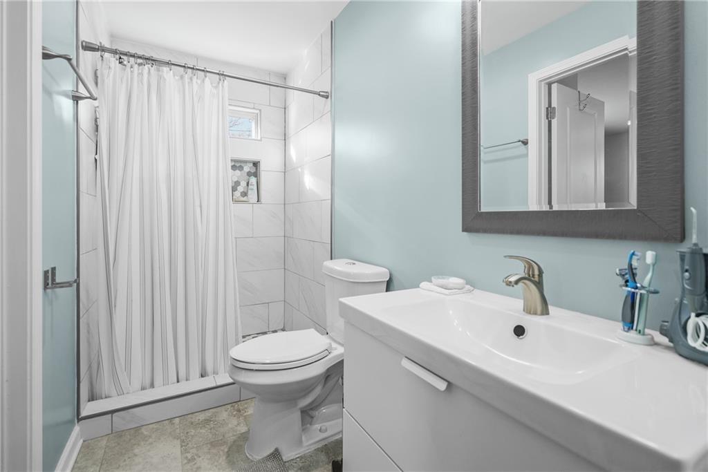 2444 Constance Street Atlanta, GA 30344 - Photo 28 of 39 a bathroom with a sink a toilet and shower