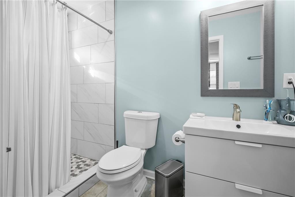 2444 Constance Street Atlanta, GA 30344 - Photo 29 of 39 a bathroom with a toilet sink and mirror