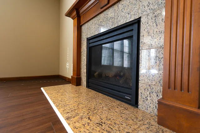 a view of livingroom with wooden floor and a fireplace