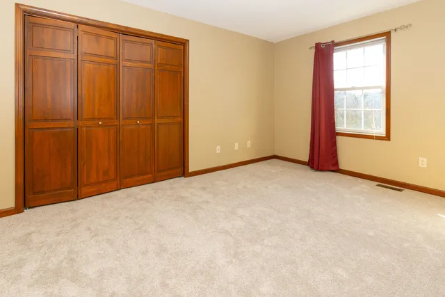 an empty room with closet area