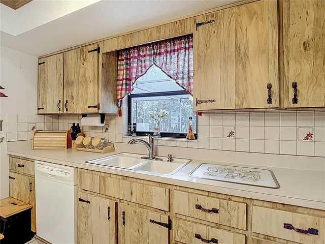 a kitchen with a sink cabinets and window