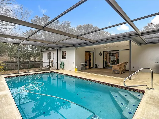 a view of a swimming pool with a patio