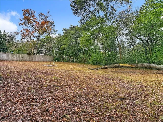 a view of dirt field with trees