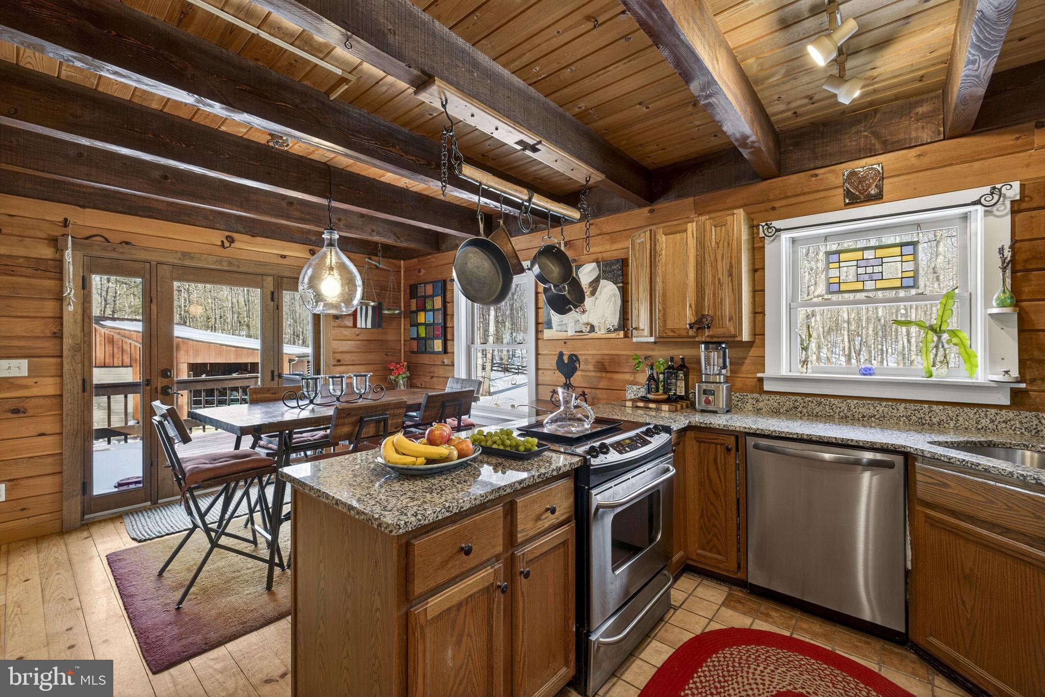 10418 Cliff Mills Road Marshall, VA 20115 - Photo 25 of 88 a kitchen that has a sink a stove and wooden cabinets