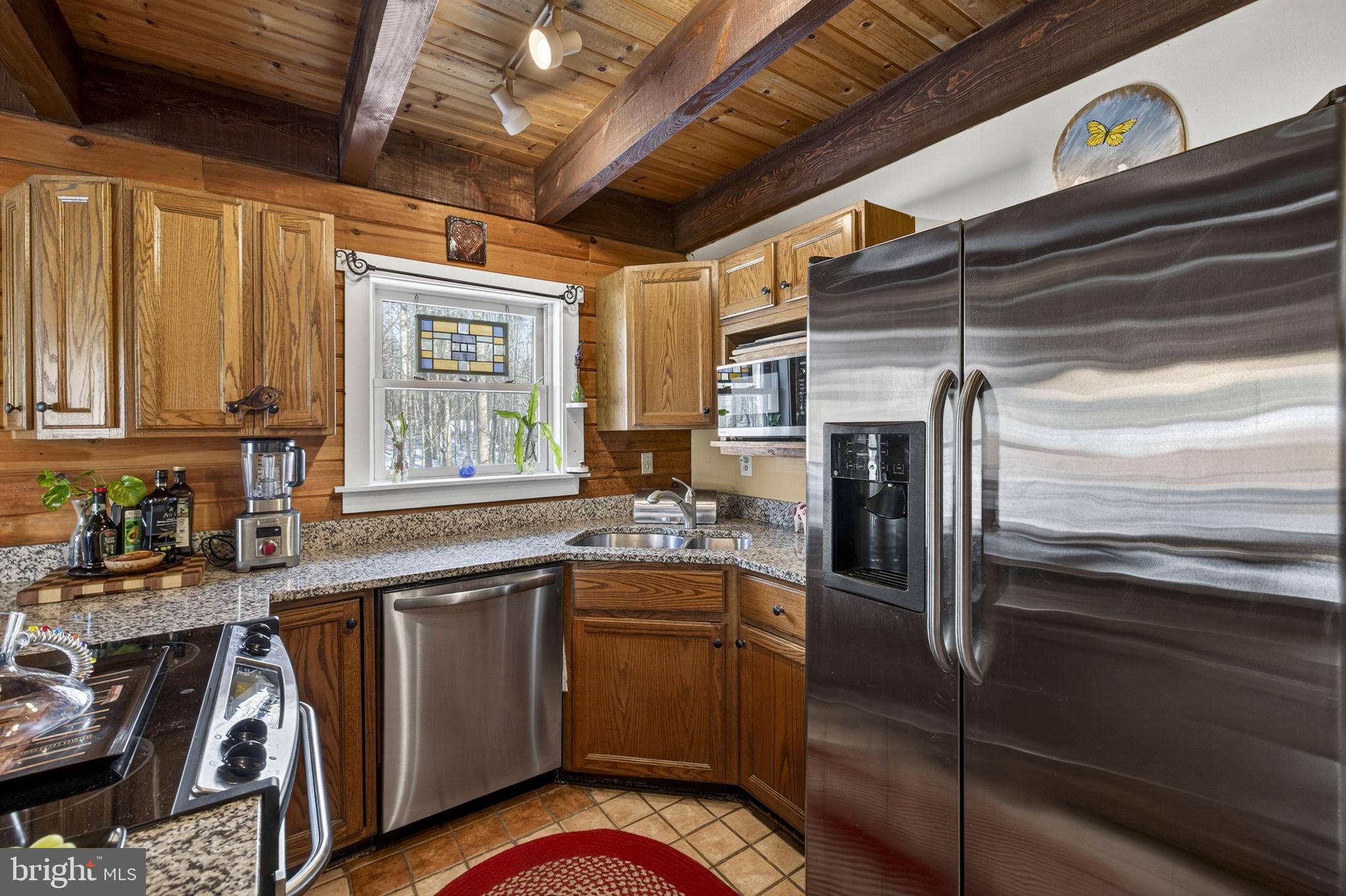 10418 Cliff Mills Road Marshall, VA 20115 - Photo 27 of 88 a kitchen with granite countertop stainless steel appliances and wooden cabinets